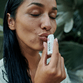 Women using Argan oi lip balm