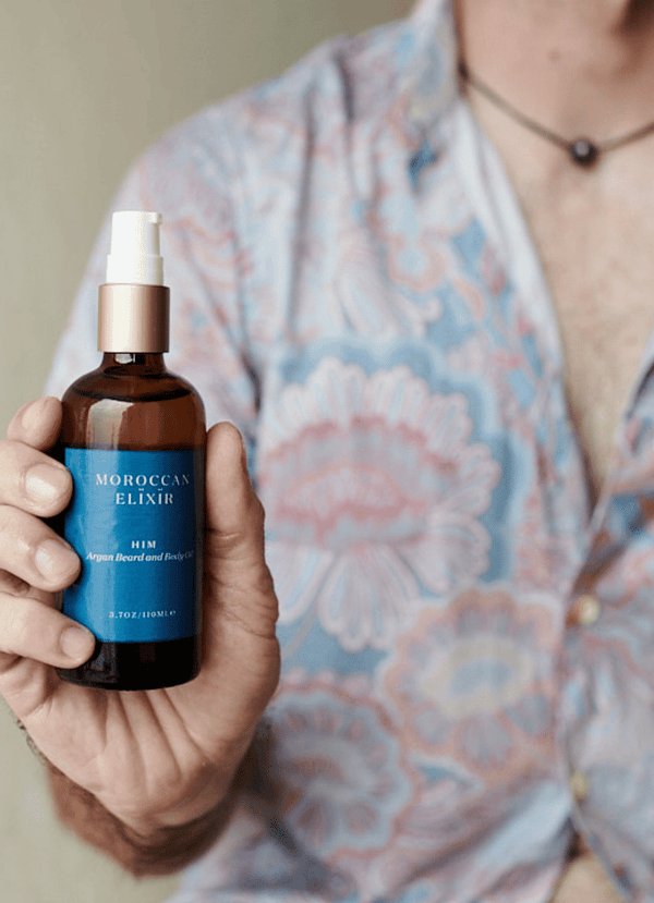 Model holding HIM men's oil - Moroccan Elixir