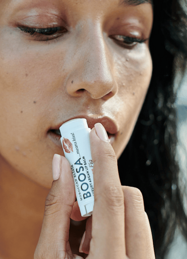 Women using fig lip balm 