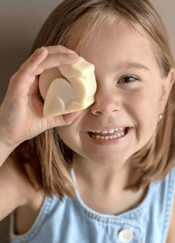 little girl holding camel milk soap
